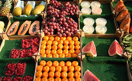 Several types of fruit displayed in boxes